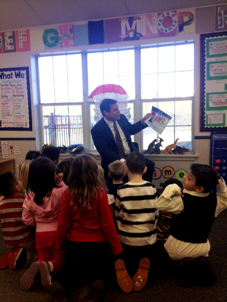 Scott reads a holiday story to Ms. Torres class