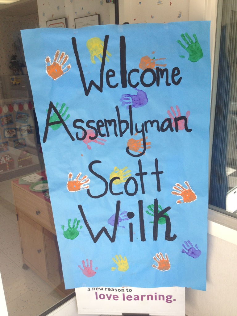 A sign made by the students at KinderCare Valencia greets Scott
