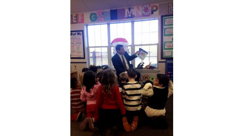 Scott reads a holiday story to Ms. Torres class